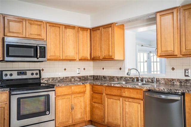 kitchen featuring sink, backsplash, and stainless steel appliances