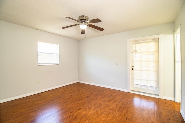 empty room with hardwood / wood-style flooring, plenty of natural light, and ceiling fan