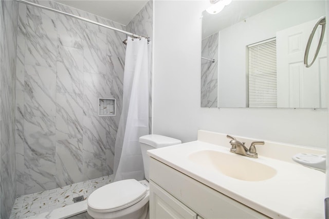 bathroom featuring vanity, curtained shower, and toilet