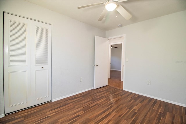 unfurnished bedroom featuring dark hardwood / wood-style floors, a closet, and ceiling fan