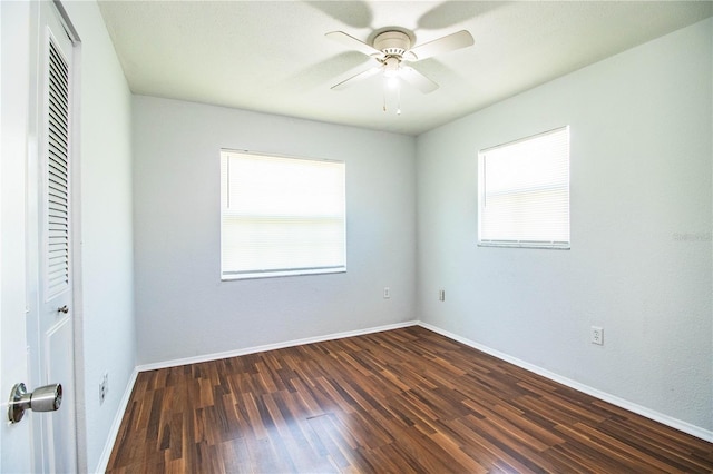 unfurnished bedroom with dark wood-type flooring, ceiling fan, and multiple windows