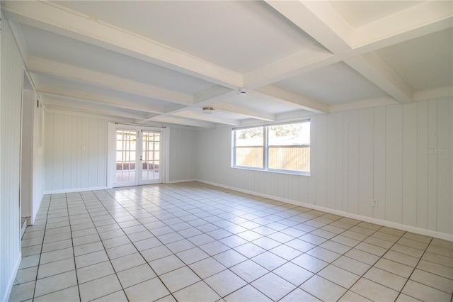 empty room featuring light tile patterned flooring, beam ceiling, and french doors