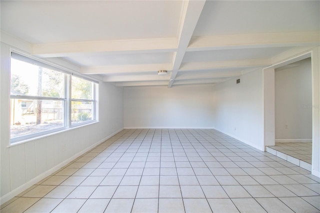 unfurnished room featuring light tile patterned flooring and beam ceiling