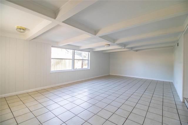 spare room with beamed ceiling, coffered ceiling, and light tile patterned floors