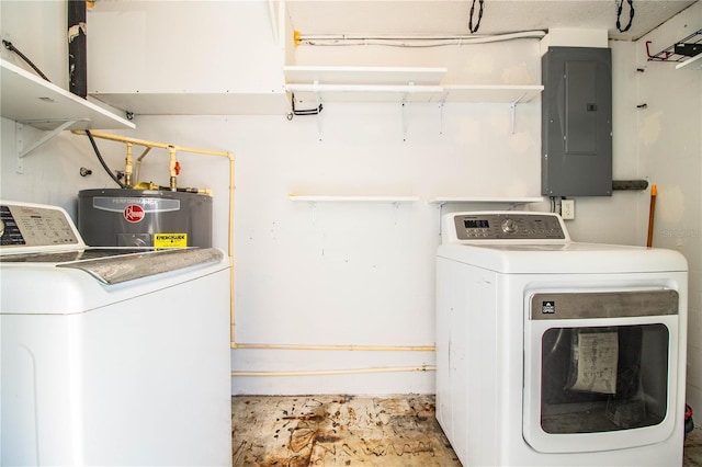 clothes washing area featuring electric panel, electric water heater, and washer and clothes dryer