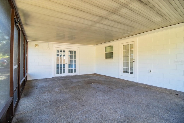 unfurnished sunroom featuring wooden ceiling and french doors