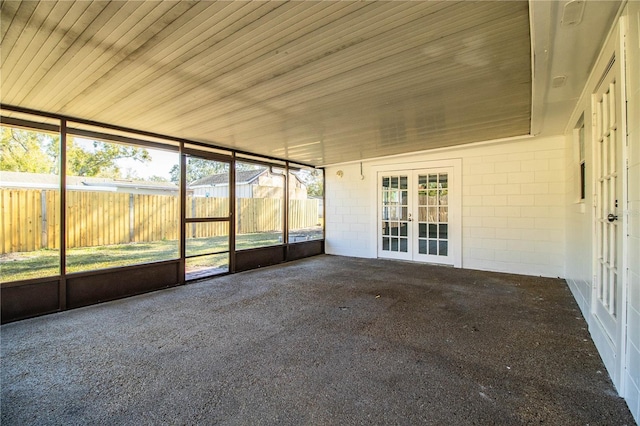 unfurnished sunroom with wooden ceiling and french doors