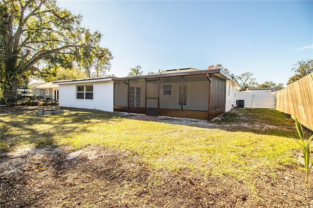 rear view of property with french doors, a yard, and cooling unit