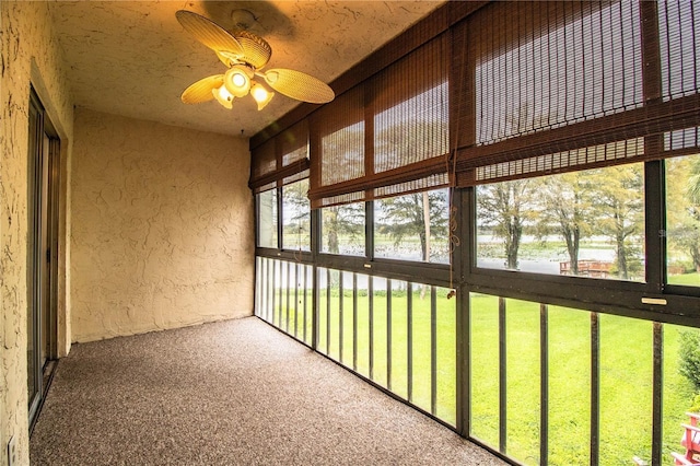 unfurnished sunroom featuring ceiling fan