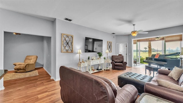 living room with ceiling fan and light wood-type flooring