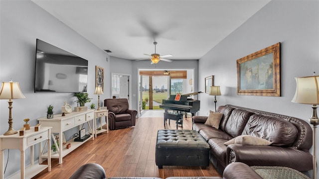 living room featuring ceiling fan and light wood-type flooring