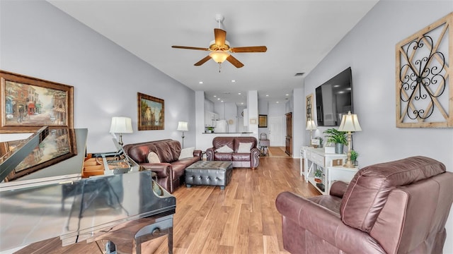 living room with light hardwood / wood-style flooring and ceiling fan