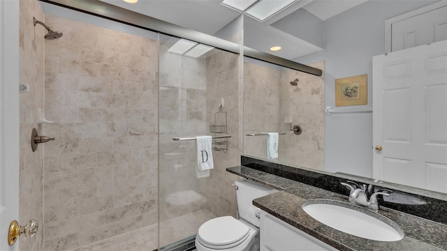 bathroom with an enclosed shower, vanity, and toilet