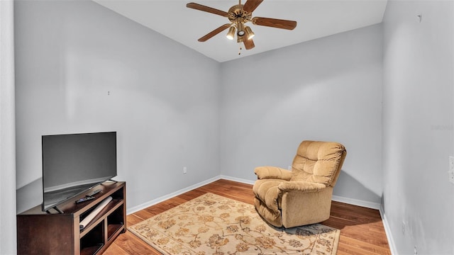 living area with light hardwood / wood-style floors and ceiling fan