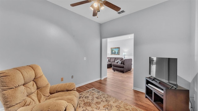 living room with light hardwood / wood-style floors and ceiling fan