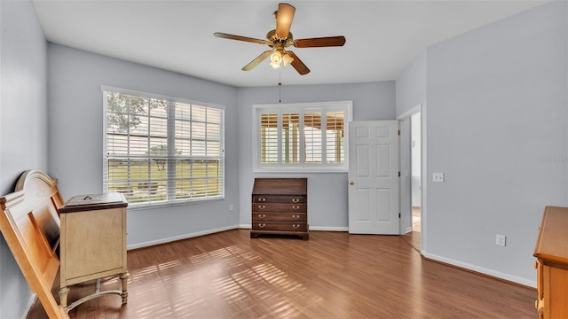 sitting room featuring hardwood / wood-style floors and ceiling fan