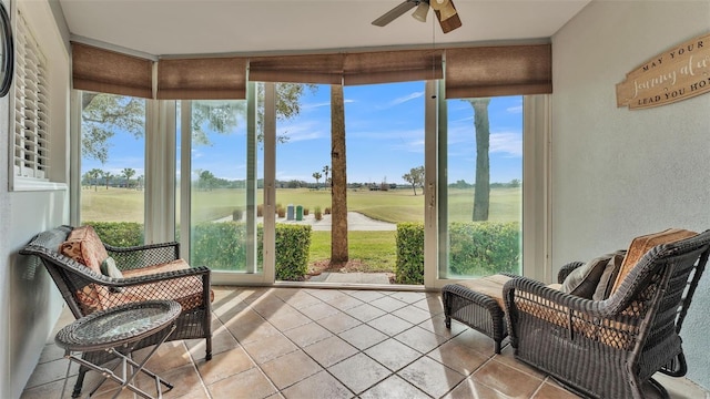 sunroom featuring ceiling fan