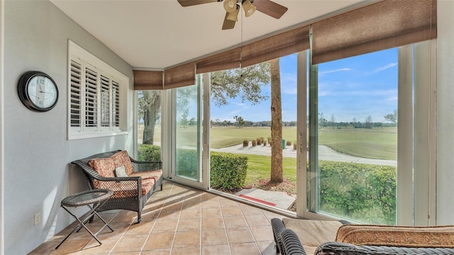 sunroom featuring ceiling fan