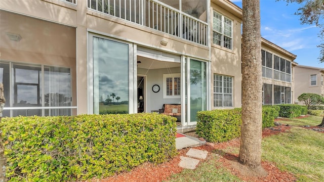 view of exterior entry with a yard