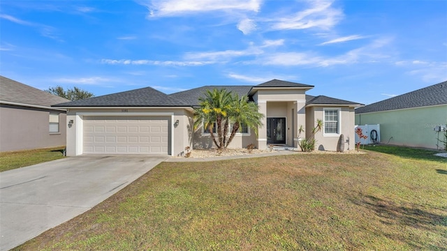 view of front facade with a garage and a front lawn