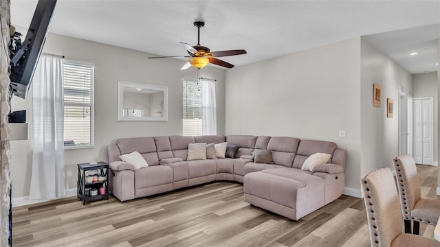 living room with ceiling fan and light hardwood / wood-style floors