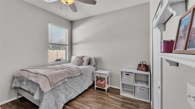 bedroom with dark wood-type flooring and ceiling fan