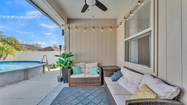 view of patio featuring ceiling fan, outdoor lounge area, and a fenced in pool