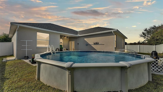 view of pool at dusk