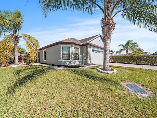 view of front of property featuring a garage and a front lawn