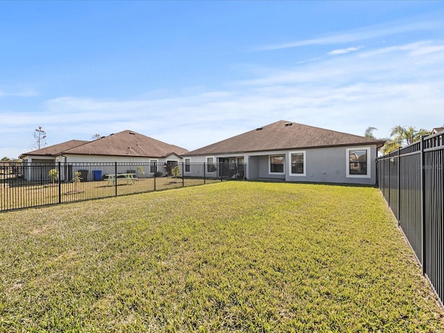 rear view of property featuring a yard