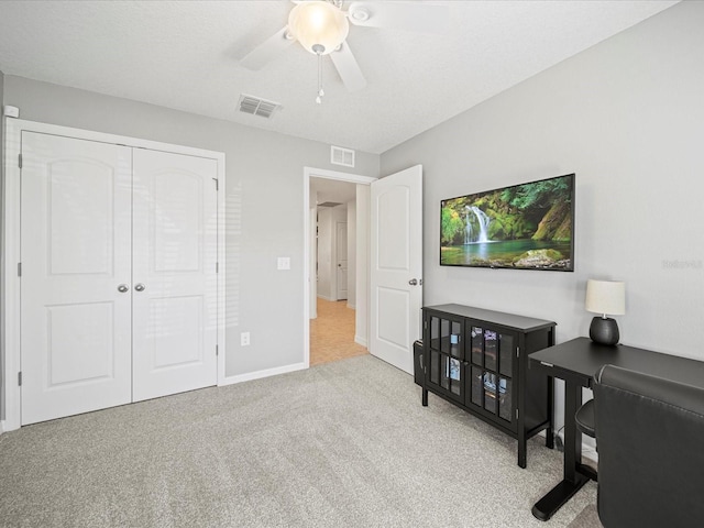 office area featuring light colored carpet and ceiling fan