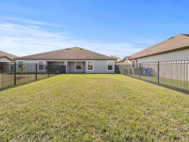 rear view of house with a lawn