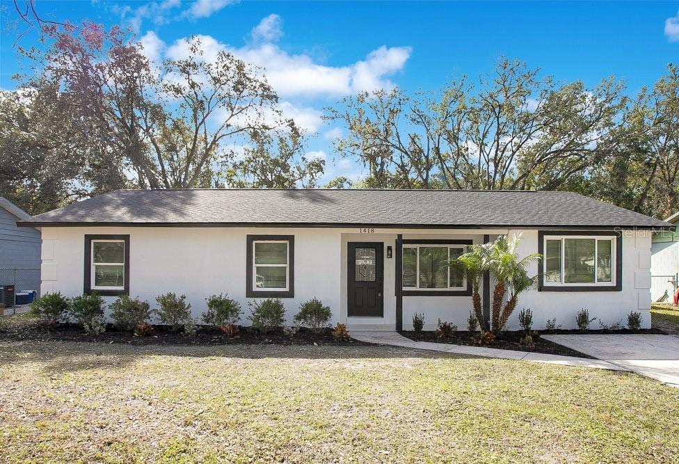 ranch-style house with a front lawn