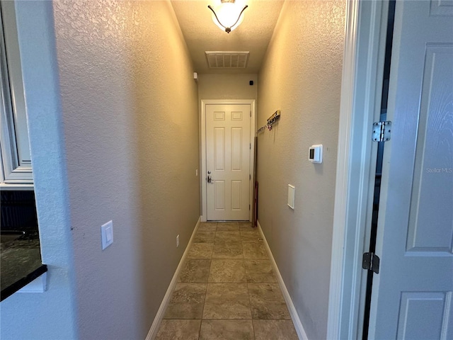 hall with a textured ceiling