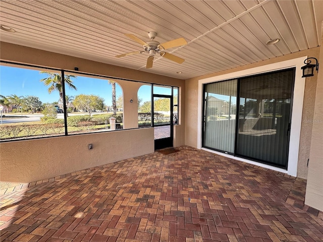 unfurnished sunroom with wooden ceiling and ceiling fan