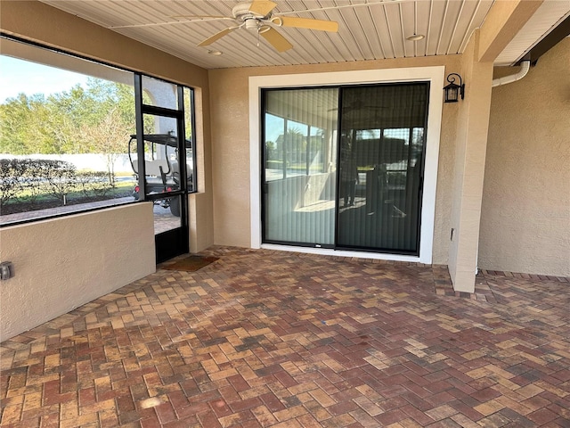 doorway to property featuring ceiling fan and a patio