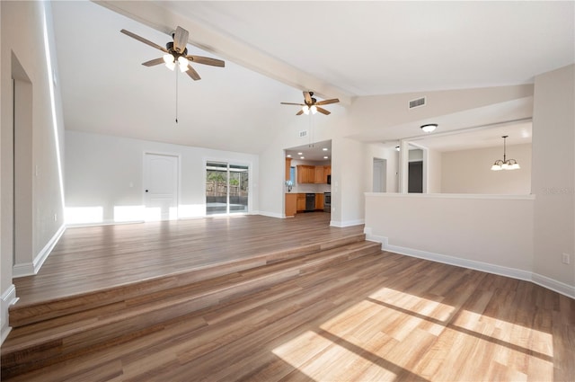 unfurnished living room featuring hardwood / wood-style flooring, high vaulted ceiling, beam ceiling, and ceiling fan with notable chandelier