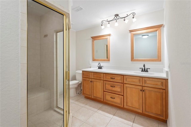 bathroom with vanity, toilet, a shower with door, and tile patterned flooring