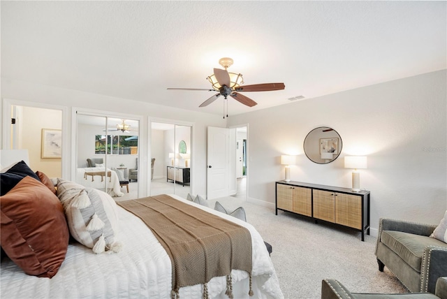 bedroom featuring light colored carpet, baseboards, and ceiling fan