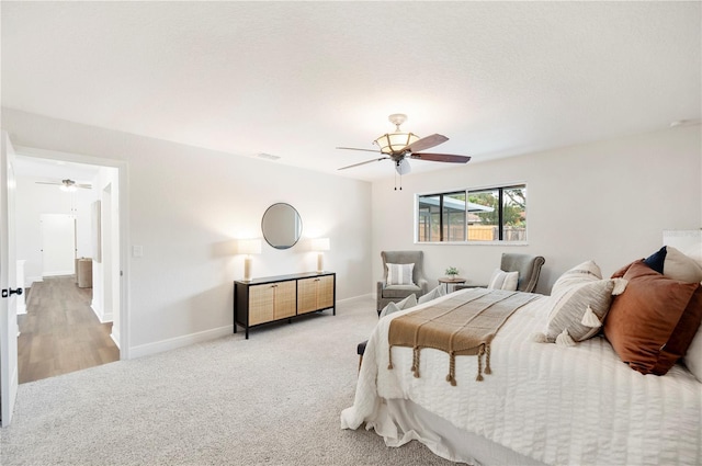 carpeted bedroom with baseboards and ceiling fan