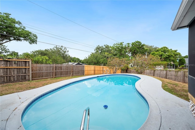 view of swimming pool featuring a fenced backyard