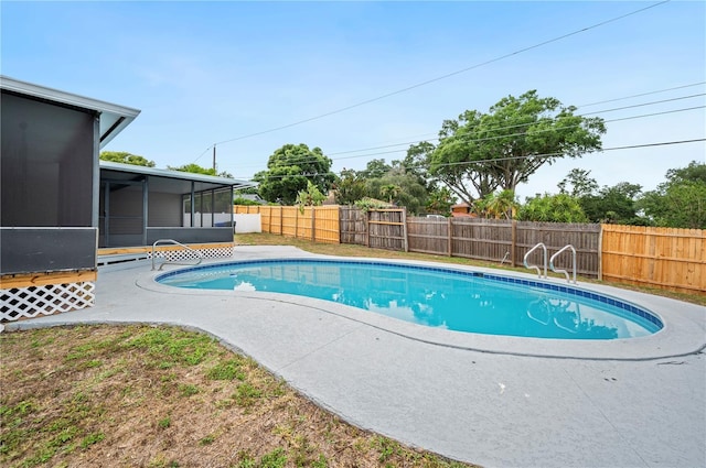 view of pool featuring a sunroom, a fenced backyard, and a patio area
