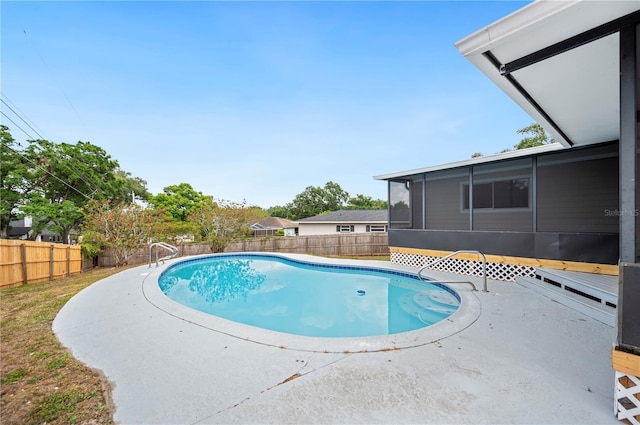 view of pool featuring a sunroom, a fenced backyard, and a patio area