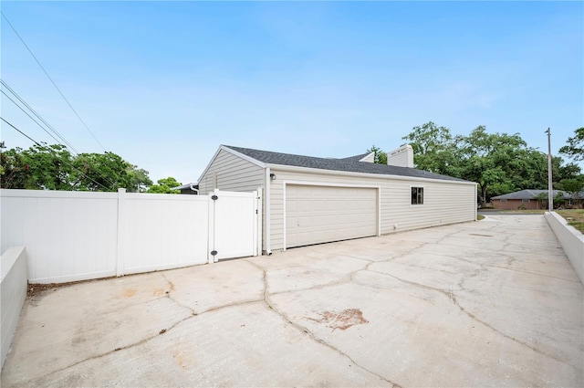garage with fence and a gate