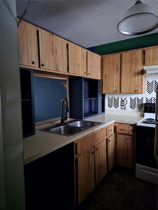 kitchen featuring electric stove, sink, and a textured ceiling