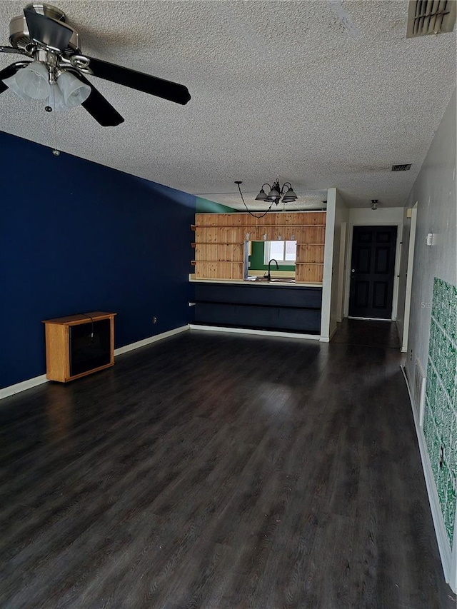 unfurnished living room with dark hardwood / wood-style flooring, sink, a textured ceiling, and ceiling fan