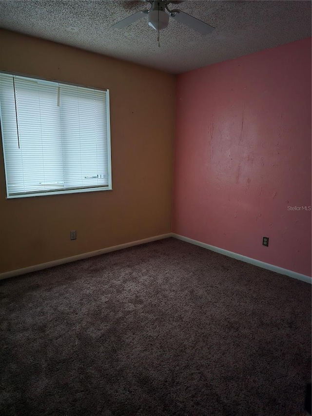 spare room featuring carpet, a textured ceiling, and ceiling fan