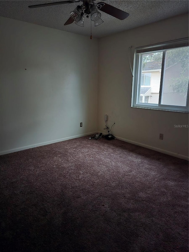 spare room featuring ceiling fan, a textured ceiling, and carpet