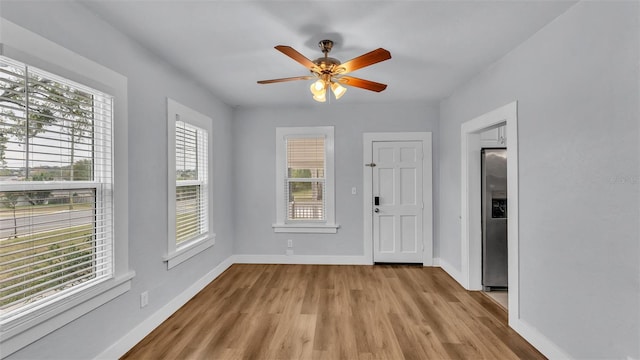 unfurnished room with ceiling fan and light wood-type flooring