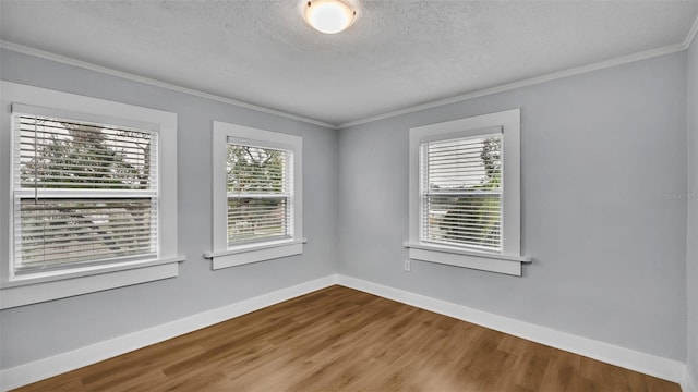 unfurnished room with crown molding, hardwood / wood-style flooring, and a textured ceiling